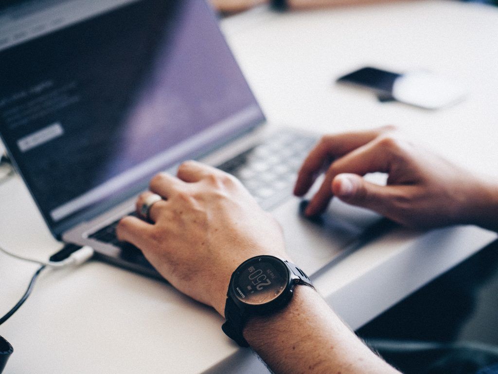 Image of man typing on a laptop that is located on the Purchasing Options webpage.